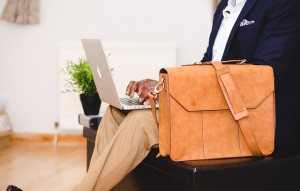 man with bag and laptop makes freeconference.com conference call