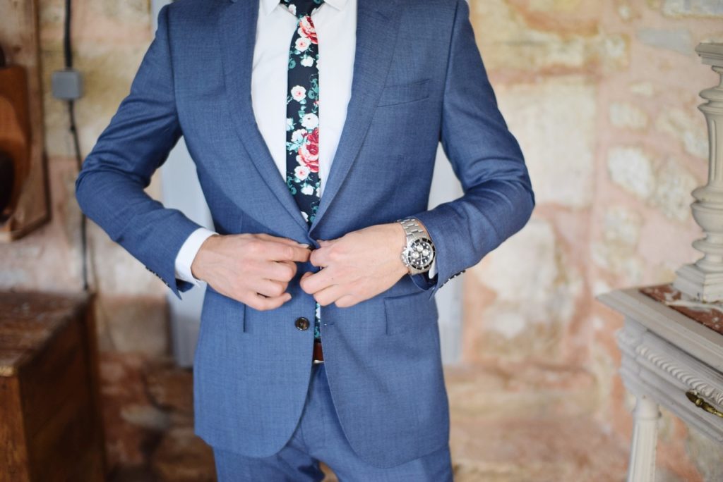 man dressed up in suit and tie preparing for important conference call