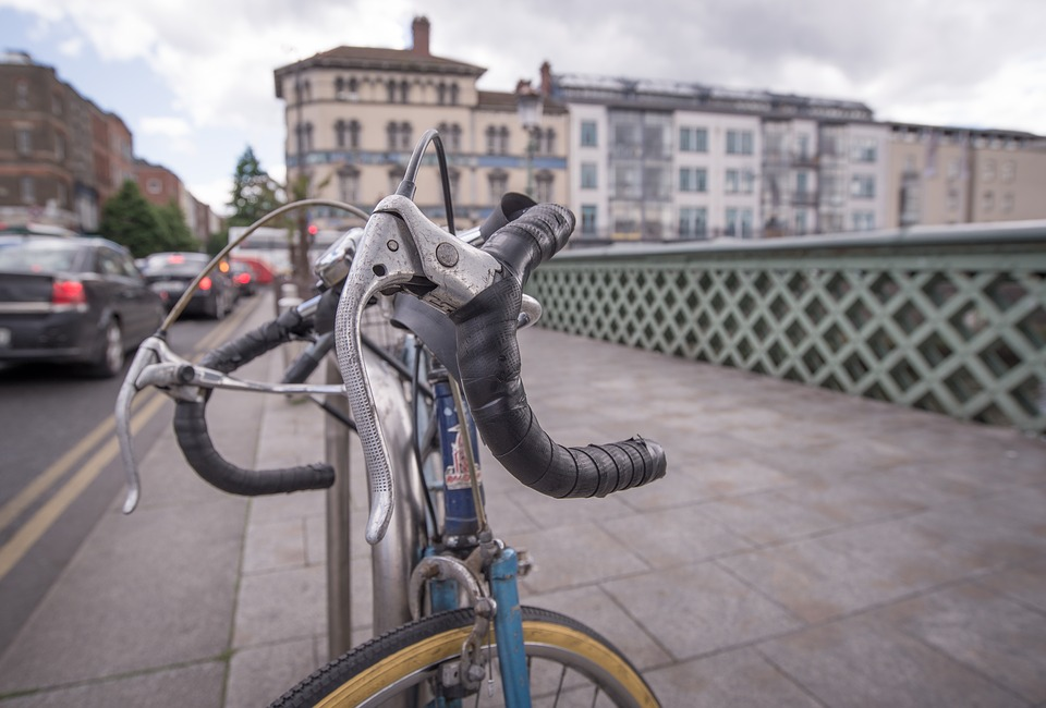 bike bicycle locked beside busy street during the day