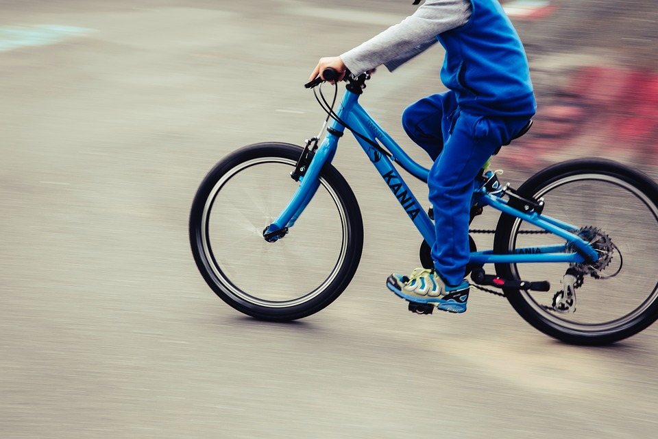 boy riding on a bicycle in the street 