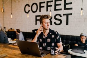 guy on phone with laptop