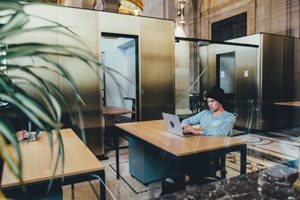 guy in library with laptop