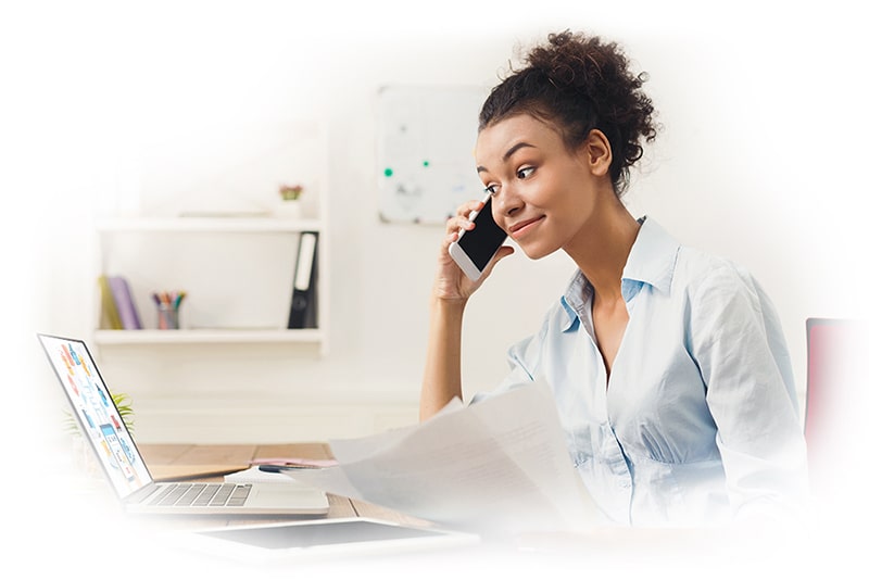 girl on a phone with a laptop