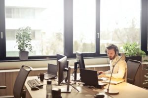 man in office with headphone